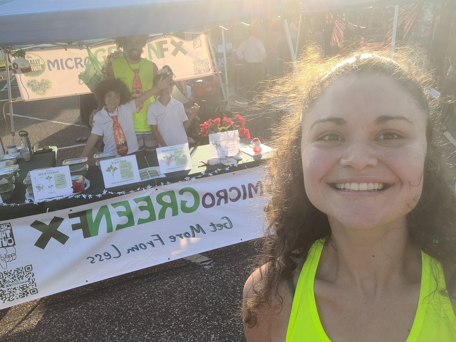 MicrogreenFX farmers market booth with fresh organic microgreens